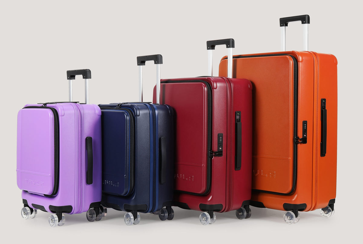 Four TRVLR hardside cases in Orchid, Nordic, Wine and Cognac, lined up from smallest to largest