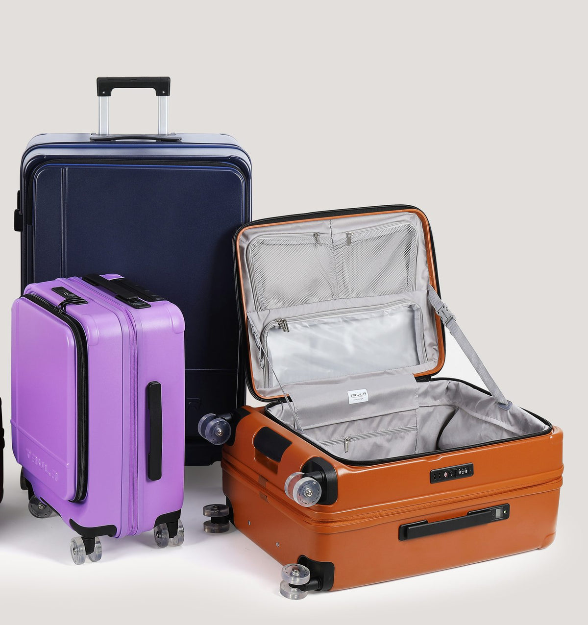 An open Cognac TRVLR case showing the grey lining, mesh pockets and compression strap
